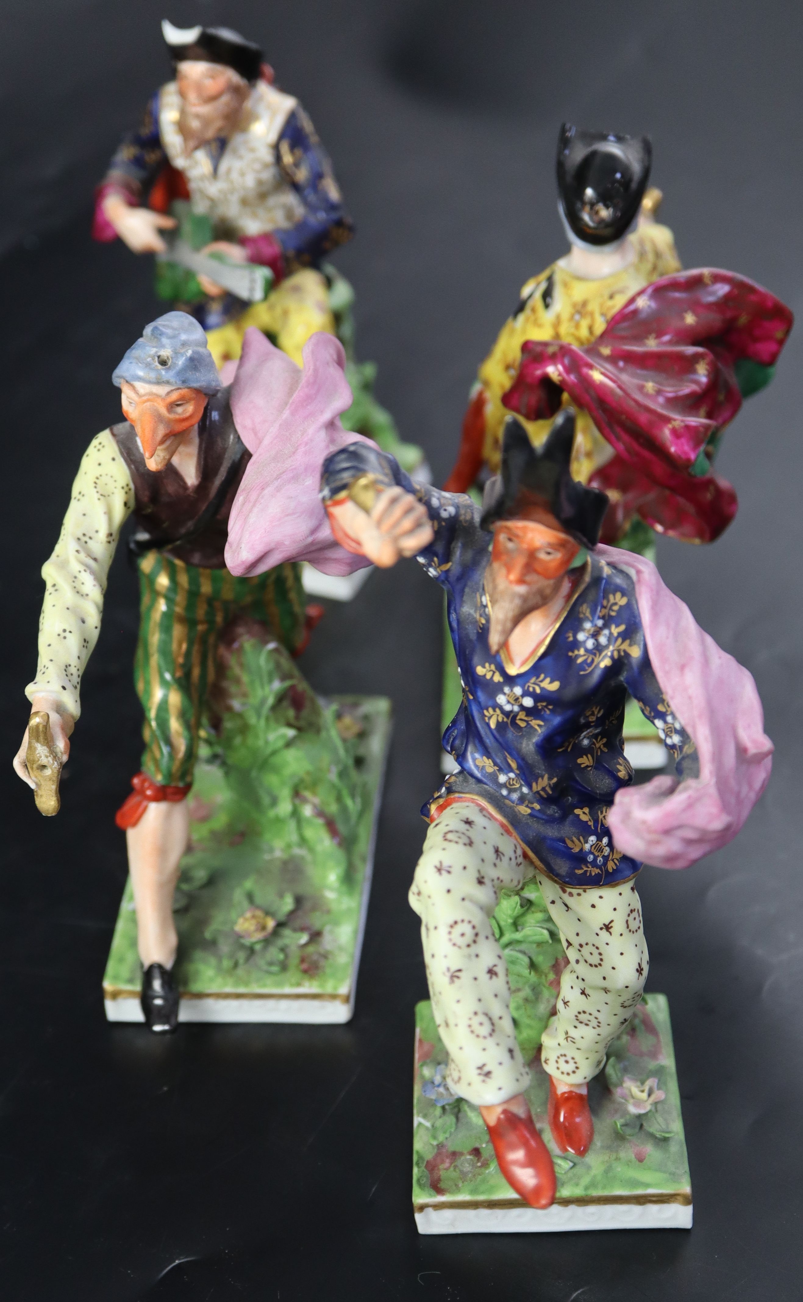 A set of four Continental porcelain Derby-style Comedia del Arte figures, largest 18.5cm